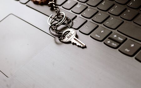 Close up of Still life of Key Ring on laptop computer keyboard. Conceptual image shown as network security key. Cyber Security, protection and privacy concepts.の写真素材