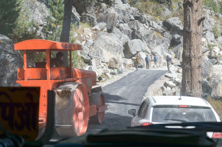 Kaza India May 2019 - A road construction roller car truck (heavy equipment engineering vehicle) in...