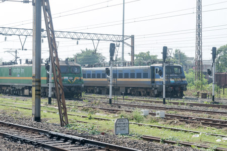 Single Line Passenger trains of Indian Railways standing on long railroad track before level...