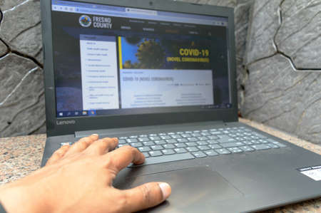 Close up hand of a medical professional browsing update of health information page about Safety Awareness Disease Control and Prevention of Coronavirus (COVID-19/2019-ncov), Middle East Respiratory Syndrome (MERS) and Sudden Acute Respiratory Syndrome (SAのeditorial素材