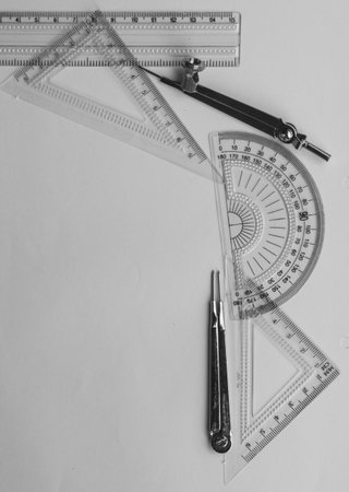 Geometric Measuring tools, Drawing items and mathematical instruments placed on white paper sheet....