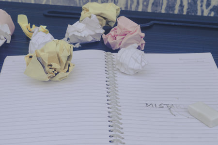 Erasing Mistake on notepad. Learning, wrong, blooper, regret sayings background. Fault, defect, careless, lesson correction and reconciliation thought concept for love friendship relationship.の写真素材