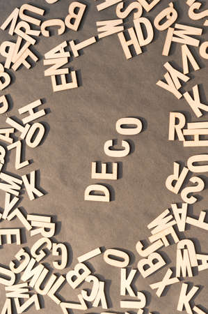Deco Word In Wooden Cube Alphabet Letters Top View On A rustic paper Background.の写真素材