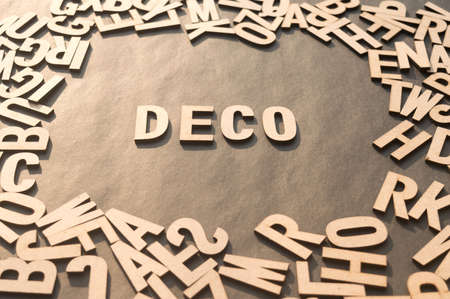 Deco Word In Wooden Cube Alphabet Letters Top View On A rustic paper Background.の写真素材