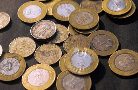 Indian COINS CURRENCY ON RUSTIC FLOOR.の写真素材