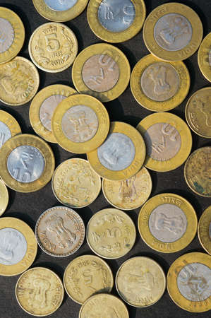 Mix of Gold Colored Indian Rupee Coin currency on rustic floor. Full Frame. Table Top View. Business Finance and financial Investment Background. Close Upの写真素材