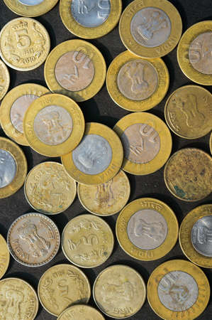 Mix of Gold Colored Indian Rupee Coin currency on rustic floor. Full Frame. Table Top View. Business Finance and financial Investment Background. Close Upの写真素材