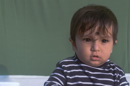 Close up portrait of one cute Sweet little baby looking shock and sad, wonder and feeling surprised...