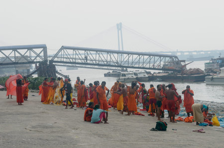 Pilgrim People are taking bath at the riverbank of the Ganges or river Hooghly . Babu Ghat, Kolkata,...