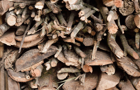 Stack of chopped firewood abstract background.の写真素材