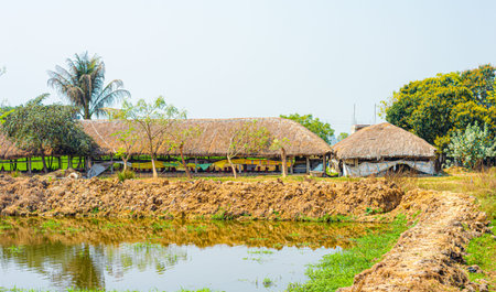 Typical rural Indian farming house made of hayloft near lake made with hay in the traditional indian way in rural Indian village landscape backgroundの写真素材