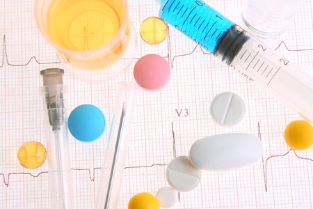 Different medicinal forms against an electrocardiogramの写真素材