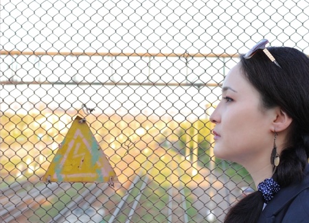 young woman on the background of the industrial landscapeの写真素材