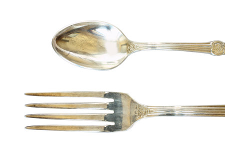 Nickel silver spoon and fork with ornament isolated on white background