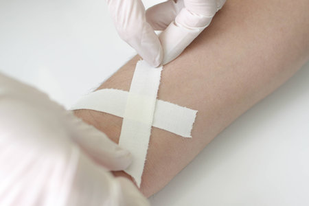 superimposition of cohesive bandage on a wound to his wrist,