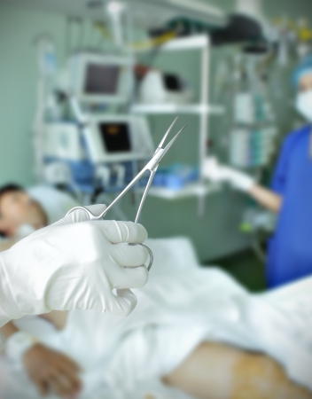 medical instrument in the hand against hospital ward with the patient のeditorial素材