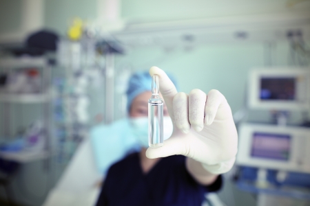Doctor actively demonstrates ampule of medicine の写真素材