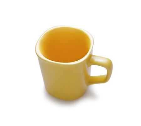 Empty yellow ceramic mug  Isolated on whiteの写真素材