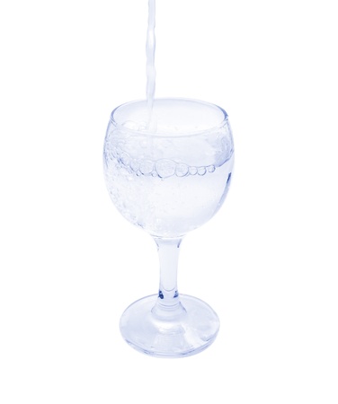 pouring water on a glass on white backgroundの写真素材