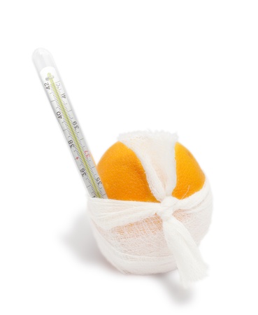 orange with a bandage and a thermometer  The concept of disease  Isolated on white の写真素材