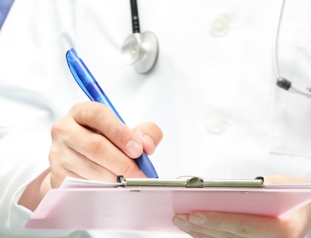 doctor with a clipboard wrote on paper の写真素材