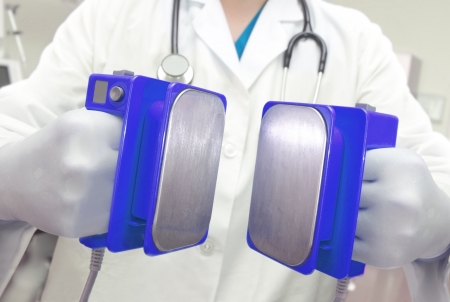 Defibrillator is ready for discharge  Doctor with electroshock in hand の写真素材