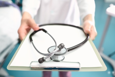 hands of the doctor with a clipboard and a stethoscope  Humorous view の写真素材
