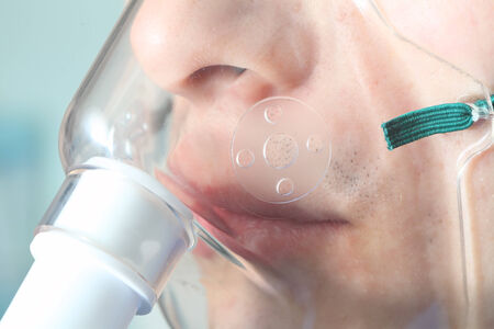 Oxygen mask on a patient の写真素材
