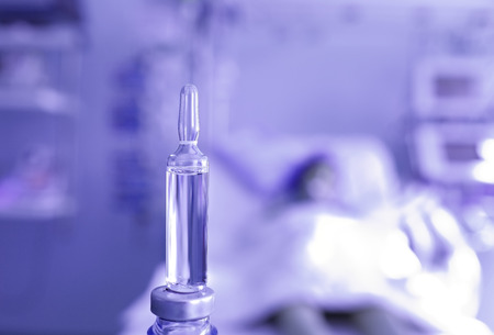 The disease concept. Drug on background of bed with patient.の写真素材