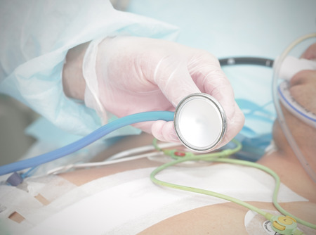 Stethoscope in the hands of the doctor to the patient's background の写真素材