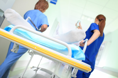 Urgency patient with a medical escort in hospital corridorの写真素材
