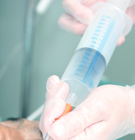 Syringe for feeding the patient in the hands of a doctorの写真素材