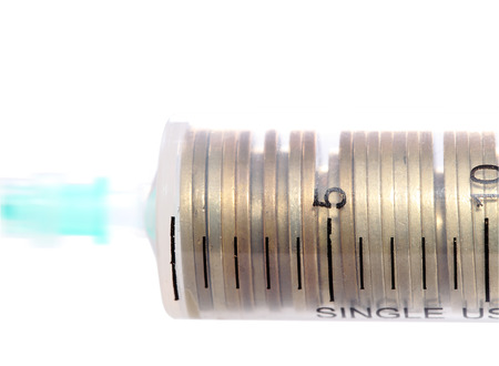 Syringe with coins concept financial investmentsの写真素材