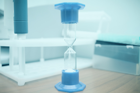 Hourglass macro on the desktop in a laboratoryの写真素材