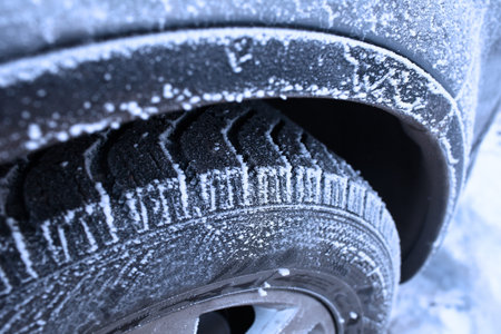 Car wheel covered with hoarfrost concept of winter weather