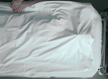 Dying man and a warm touch of a loving personの写真素材