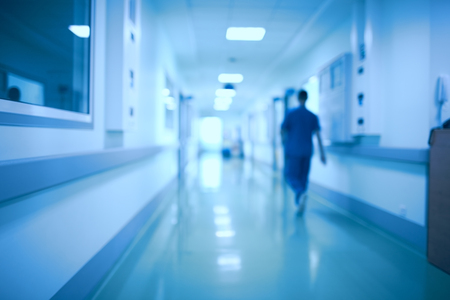 Hospital corridor and doctor as a blurred defocused background