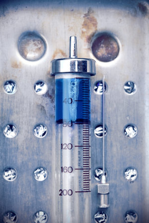 Vintage glass syringe with a drug, concept of drug addiction.の写真素材