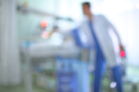 Male doctor in hospital ward, blurred background.の写真素材