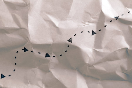 Path indicated by the arrow on old crumpled paper