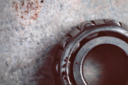 Rusty ball bearing on the old metal sheet.の写真素材