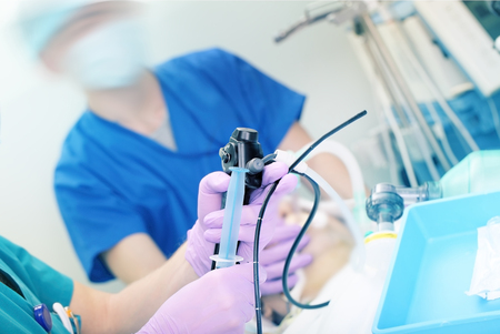 Doctor performs endoscopic procedure in hospital.の写真素材