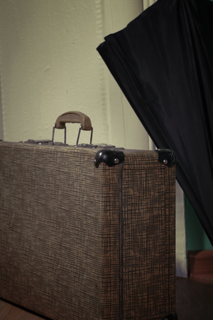 Vintage suitcase and umbrella before traveling.の写真素材