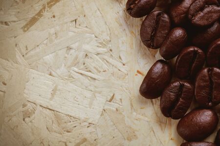 Coffee beans on particle board.の写真素材