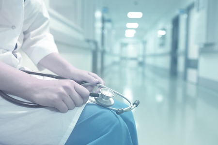 Medical doctor in empty hospital corridor.の写真素材