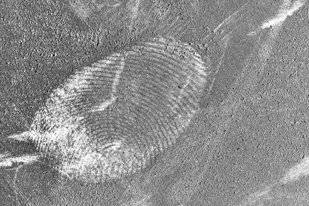 Fingerprint on the grunge dusty surface.の写真素材