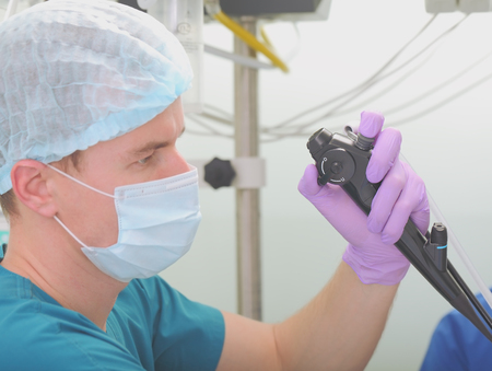 Conducting of sanation bronchoscopy. Doctor conducting the procedure intently.の写真素材