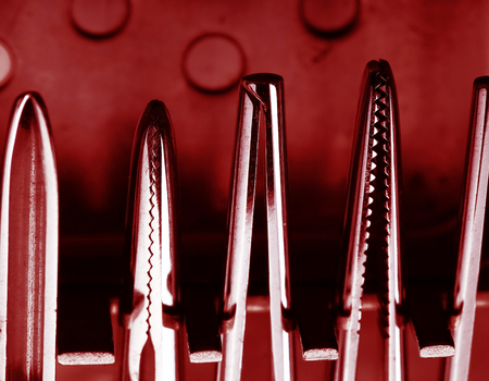 Surgical tools illuminated by the red light.の写真素材