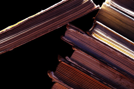 Old dirty books isolated on the black.