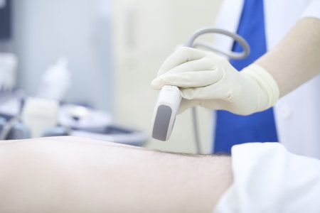 Doctor conducting ultrasound examination of abdomen to a patient.の写真素材